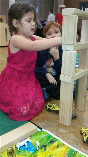 two students building with blocks